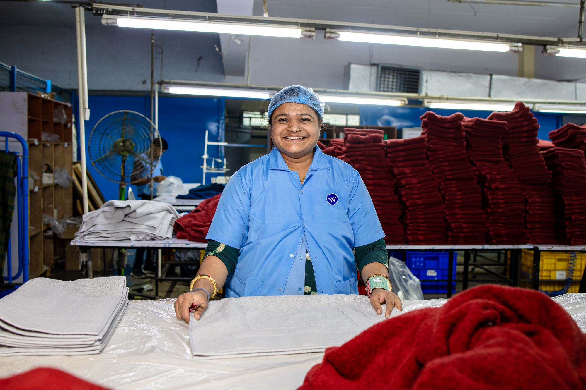 A smiling worker at a textile unit.